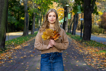 Autumn street portrait of blond girl in Park Chorzowski in Katowice, Poland.