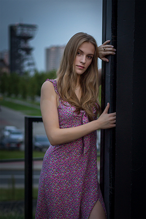 Sensual beauty portrait of blonde girl wearing a pink dress.