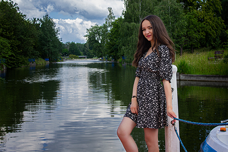 A young girl posing infornt of a river.