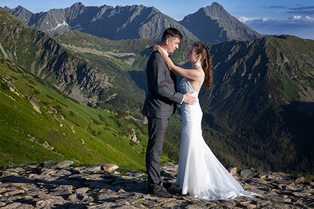 A wedding couple huging at Tatra mountains.